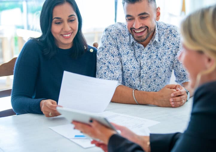 mature couple meeting with financial advisor or real estate agent at home