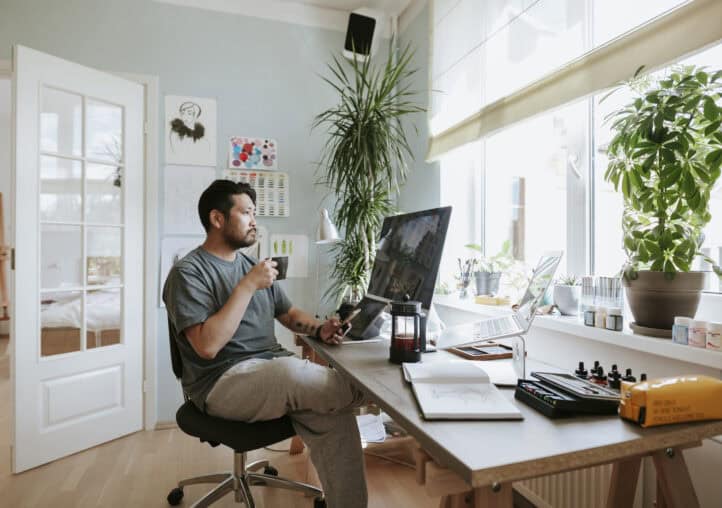 digital artist contemplates during coffee break in his home office