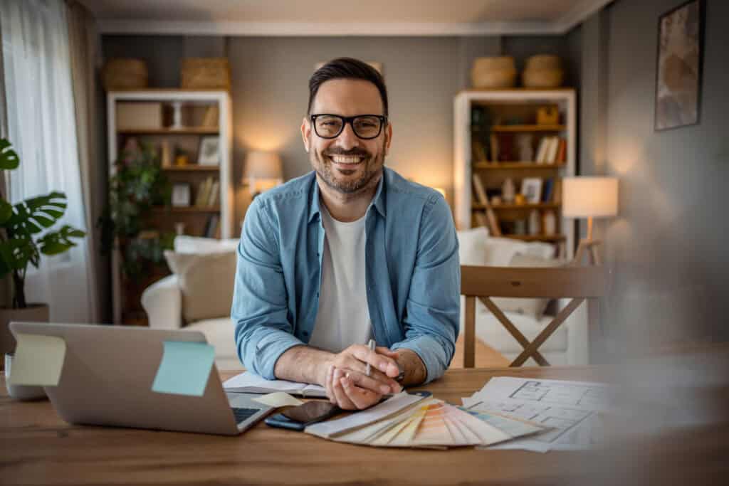 busy, focused adult freelancer sitting at a desk working from home