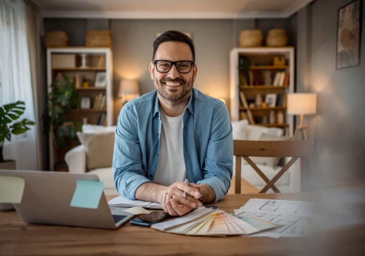 busy, focused adult freelancer sitting at a desk working from home
