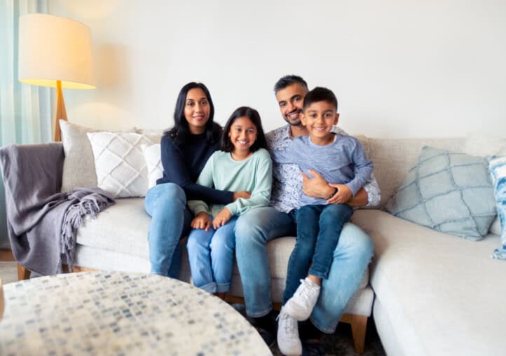 family portrait at home on the sofa. family with 2 parents and 2 children