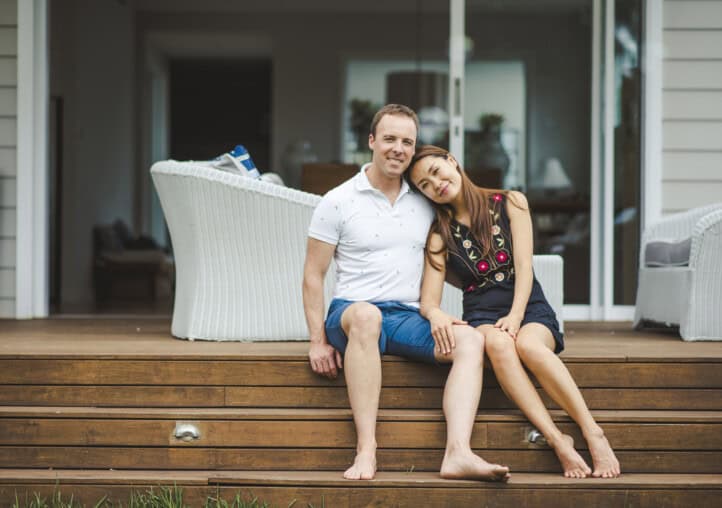 happy couple sitting on the porch